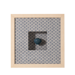 Decorative item with a blue sphere on a patterned fabric background inside a wooden frame.