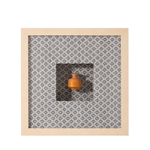 Small wooden vase on a patterned fabric background with a wooden frame.