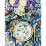 5-piece flatware set with garden green handles alongside floral-patterned plate on blue botanical tablecloth.