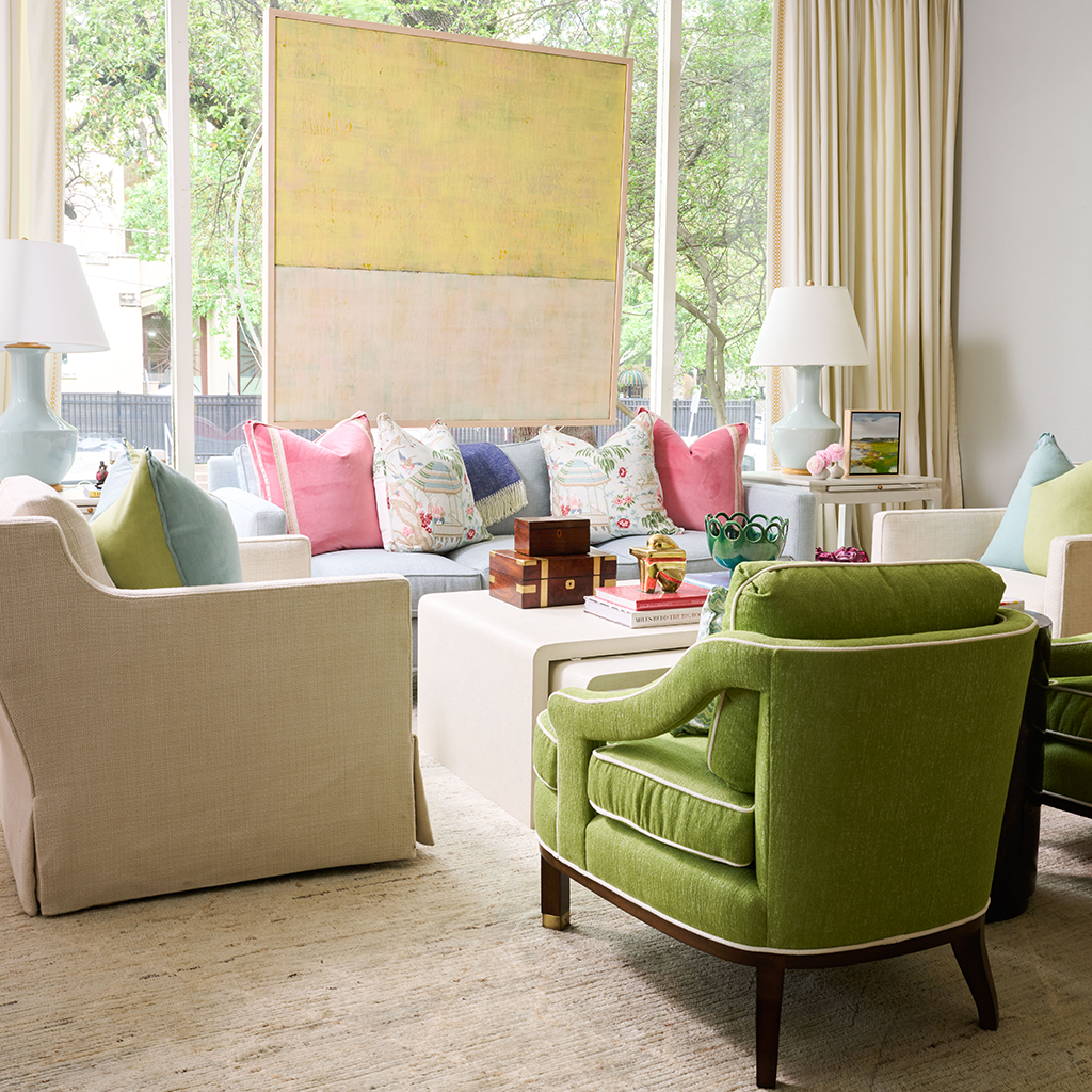 Square yellow decorative pillow with subtle texture on a beige sofa in a bright living room.