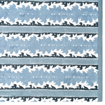 A close-up of a tablecloth pattern featuring horizontal bands of light blue, white, and dark navy, with repeating stylized leaf or bird-like motifs and dotted lines.