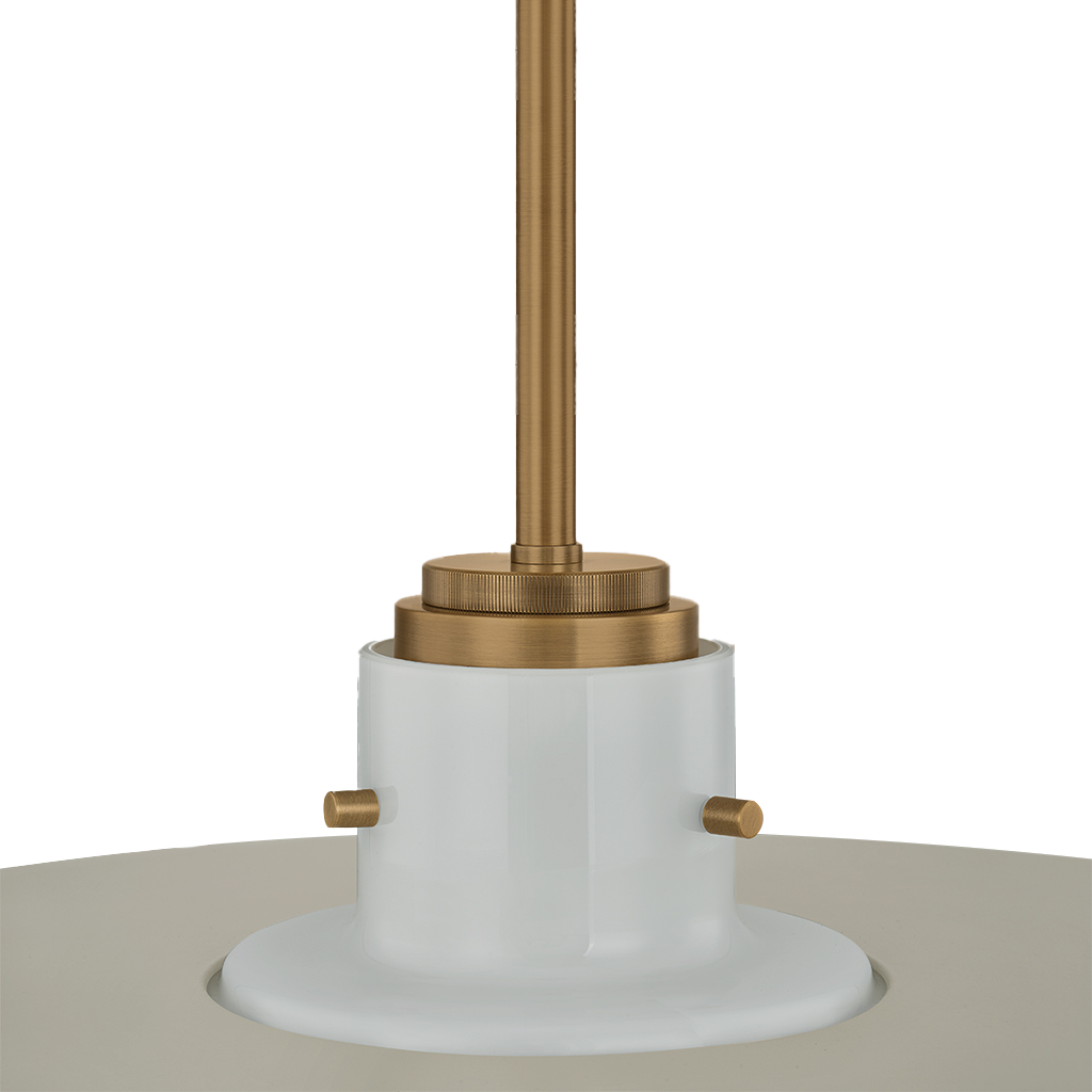 A close-up of a pendant light fixture showing a white cylindrical shade base with small brass side tabs and a brushed brass ceiling mount rod against a white background.