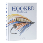 The book 'Hooked: Freshwater' by Johnny Vacay, featuring a white cover with a detailed illustration of a fly fishing lure in blue, orange, and brown, and blue title text.