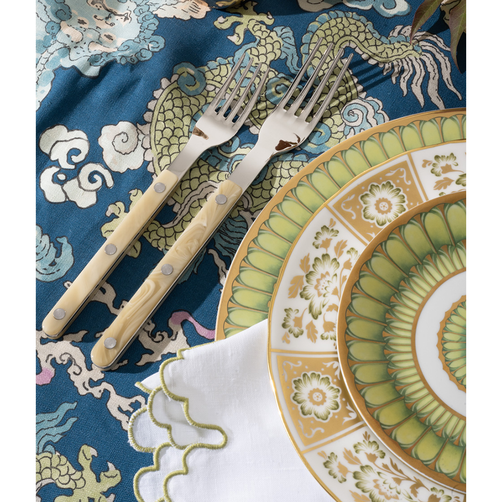 Decorative plate with intricate patterns on a blue patterned cloth