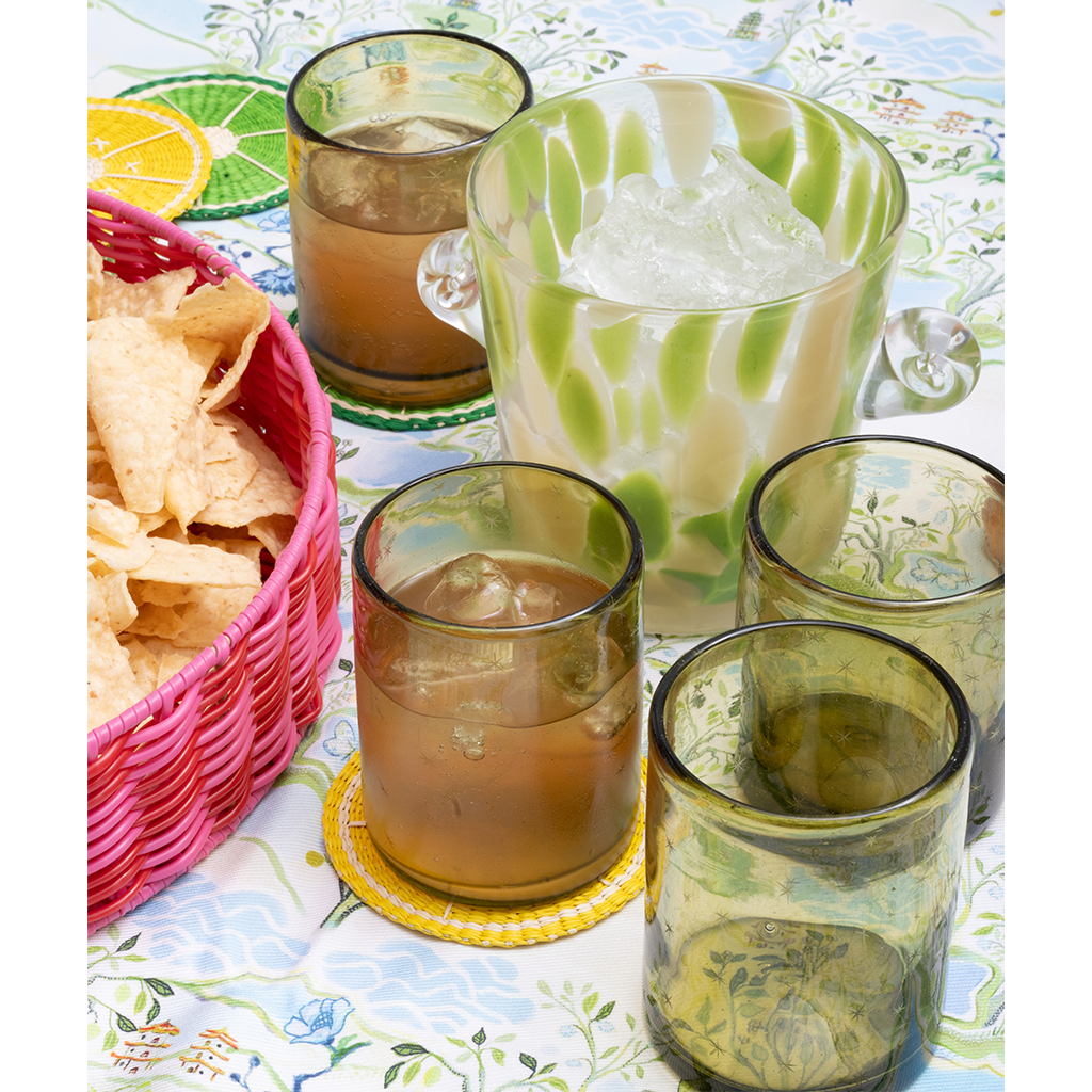 margarita glasses and an ice bucket on a blue patterned tablecloth