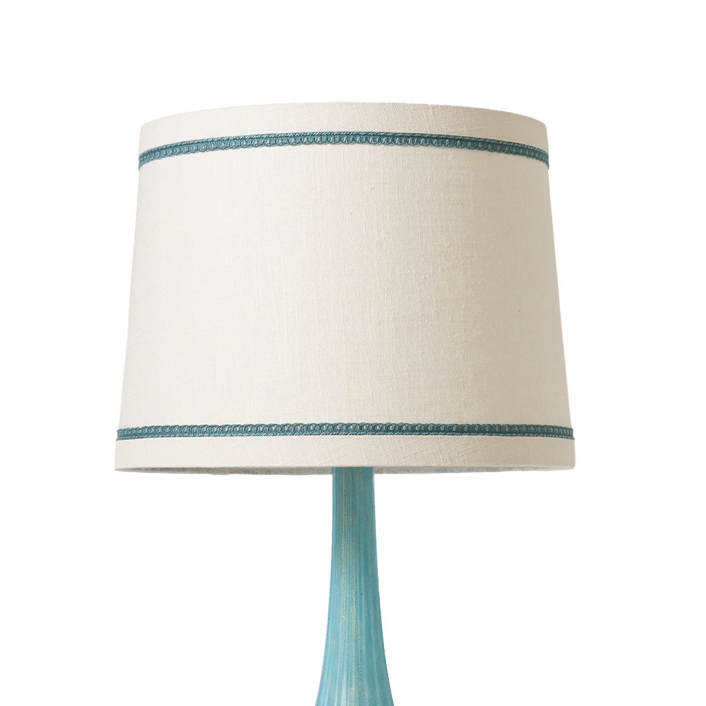 Lamp with a white shade featuring a blue band and a blue base on a white background