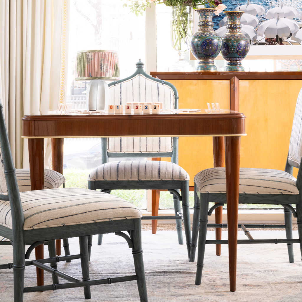 Dining room with wooden game table and chairs in a well-lit room.
