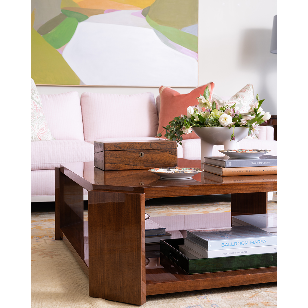 Wooden coffee table with decorative items in a living room setting