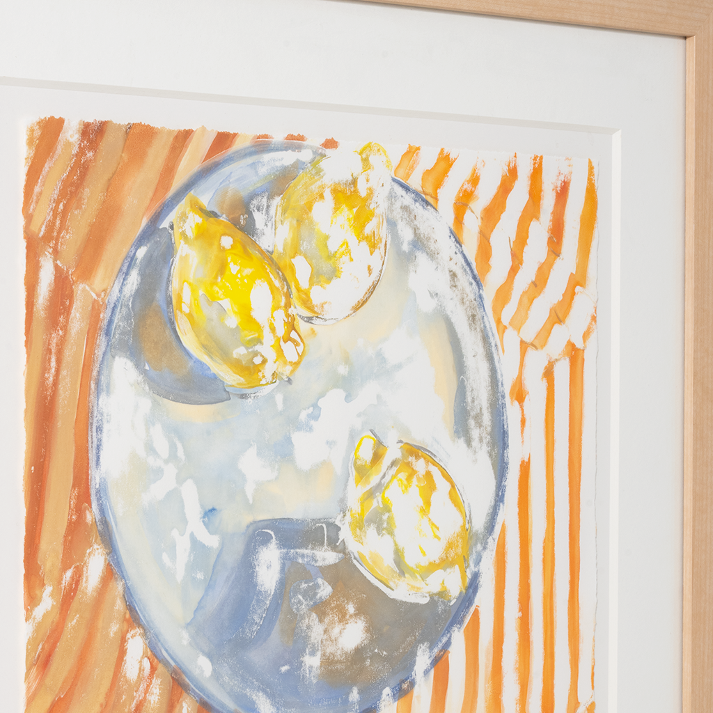 Framed artwork of lemons on a plate with abstract orange and white background