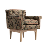 A classic armchair with a detailed paisley patterned fabric in beige, brown, and green, featuring rolled arms, tufted cushions, and light natural wood legs, shown against a plain white background.