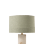 Table lamp with a marble base and green shade on a white background