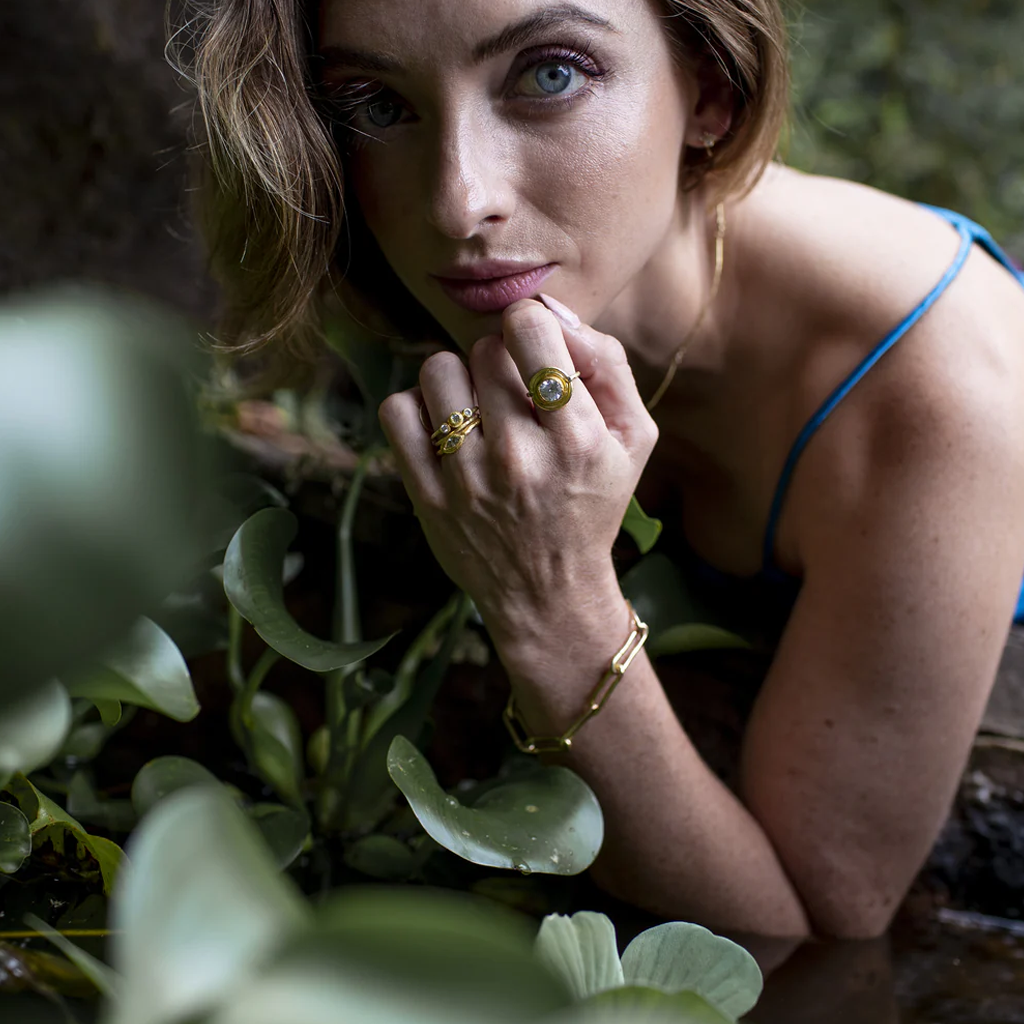 Woman with gold jewelry among plants