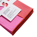 Folded pink and red napkins with a brand label on a white background