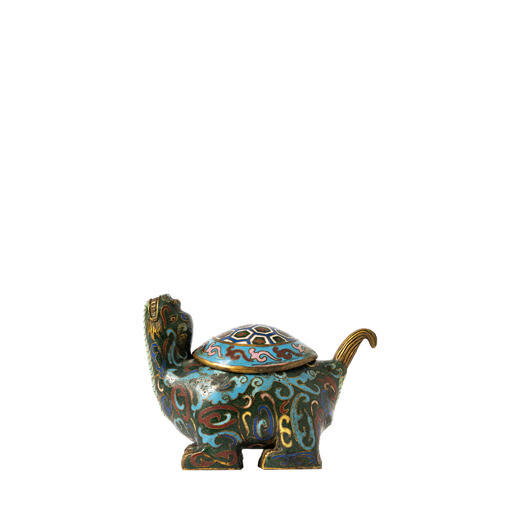 Decorative turtle figurine with intricate patterns on a white background