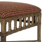 Wooden stool with a patterned cushion on a white background