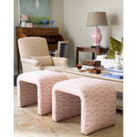 a pair of pink patterned ottomans in a living room vignette