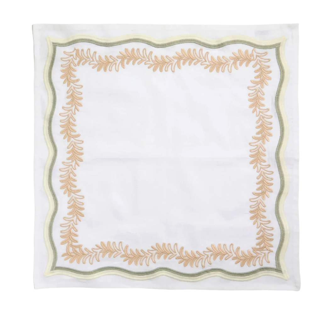 A square white napkin with a decorative border featuring a tan leafy wreath design and thin olive green and cream stripes.