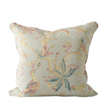 Decorative pillow with bird and floral pattern on a white background