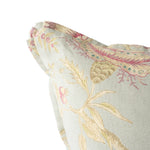 Close-up of a floral patterned fabric with pink and gold colors on a light background