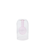 Clear glass vase with a pink interior on a white background