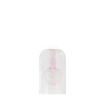 Pink glass vase in a clear plastic dome on a white background
