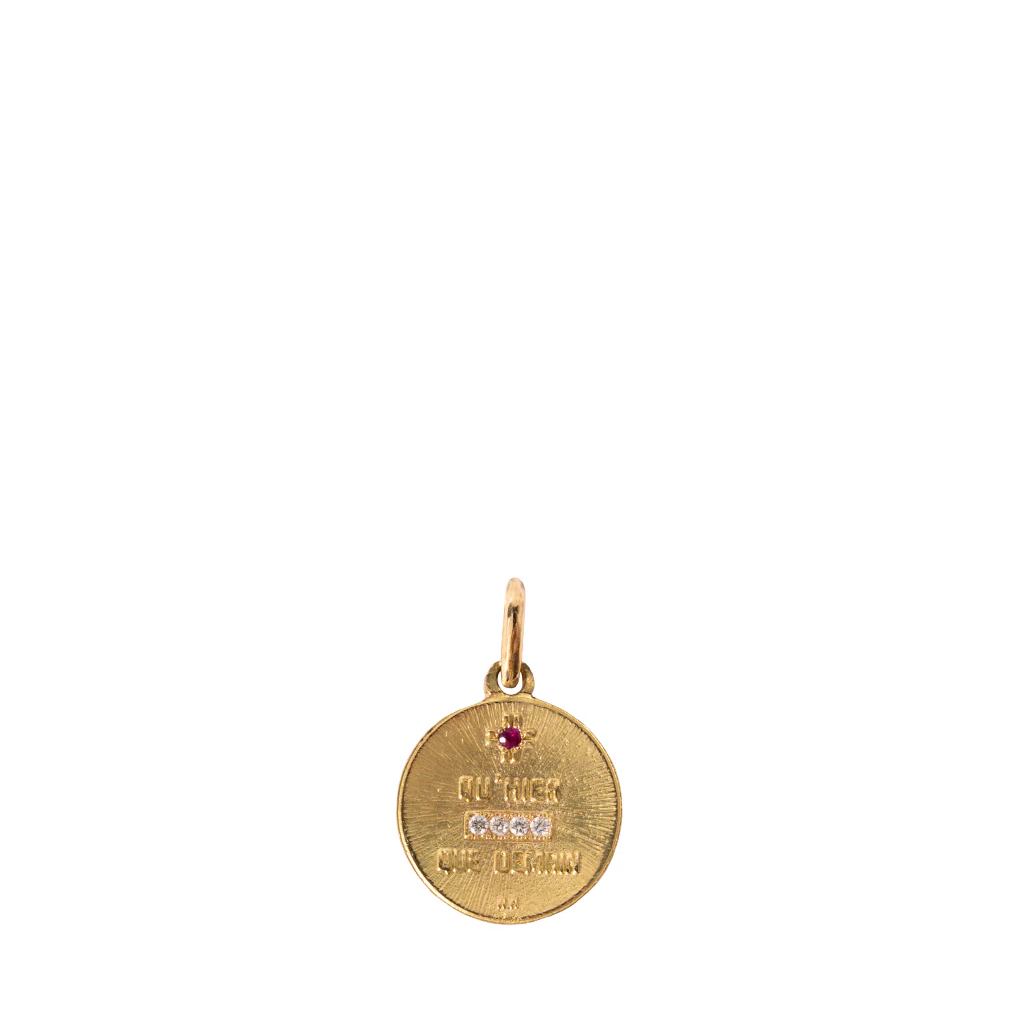 Gold pendant with a pink gemstone on a white background
