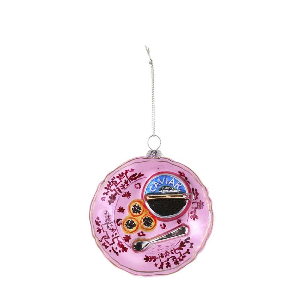 Decorative pink ornament with caviar-themed design on a white background