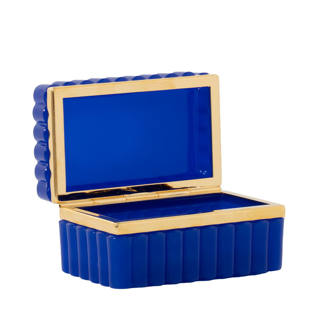 Scalloped rectangular cobalt blue box with glossy opaline finish and gold trim lining the edges.