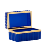 Scalloped rectangular cobalt blue box with glossy opaline finish and gold trim lining the edges.