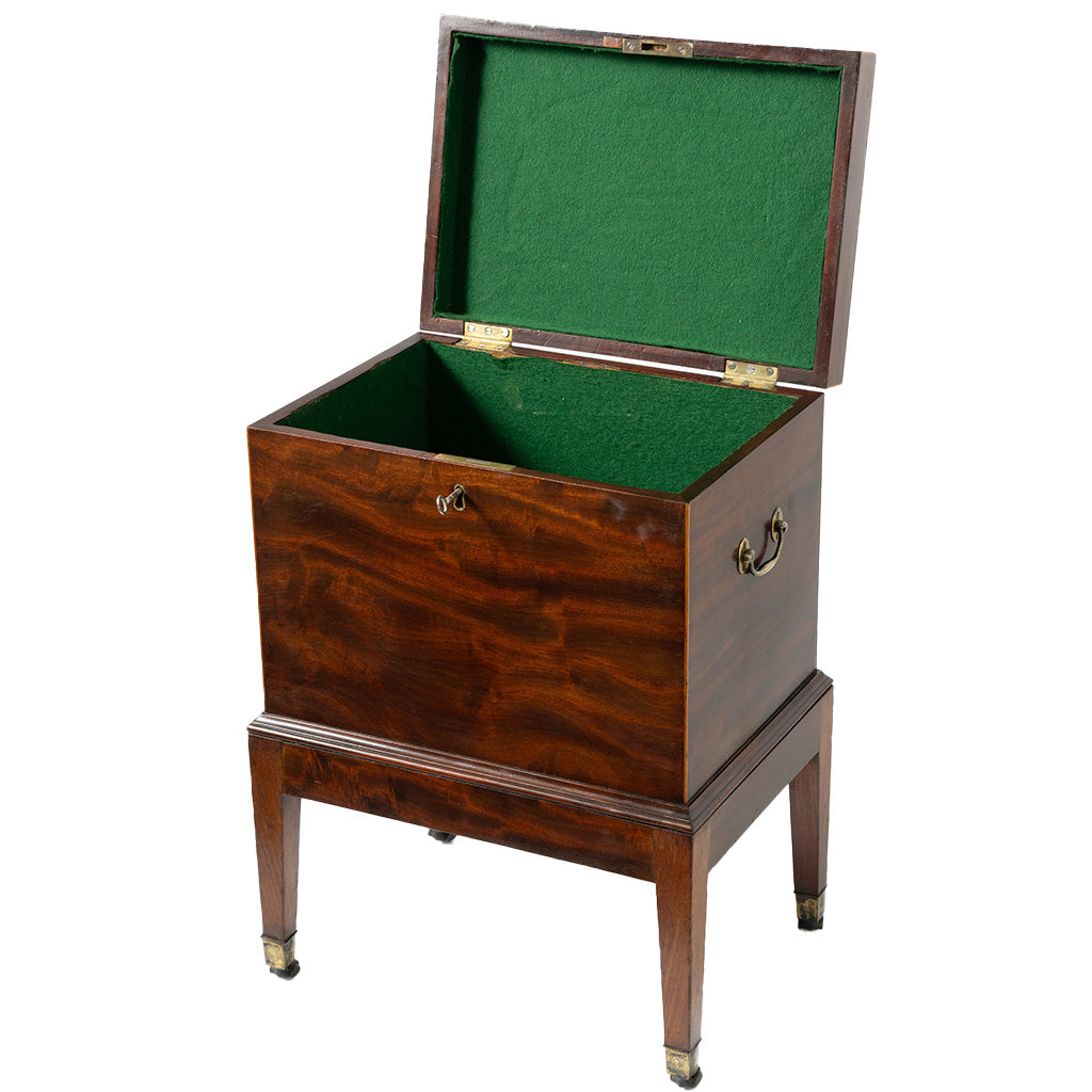 A vintage wooden chest with an open lid, featuring a rich mahogany wood grain finish, brass hardware, and a green felt-lined interior, set against a plain white background.