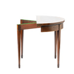 Side view of a compact wooden folding table with one semicircular leaf extended, revealing its hinged construction and green felt-lined support. The table features a warm wood finish, tapered legs, and delicate floral inlay accents, giving it an elegant antique appearance.