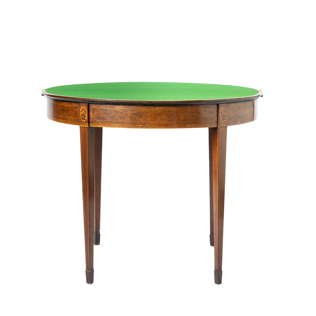 A round mahogany-style game table with a green felt playing surface and a polished brown wood frame with decorative inlays and four tapered legs.