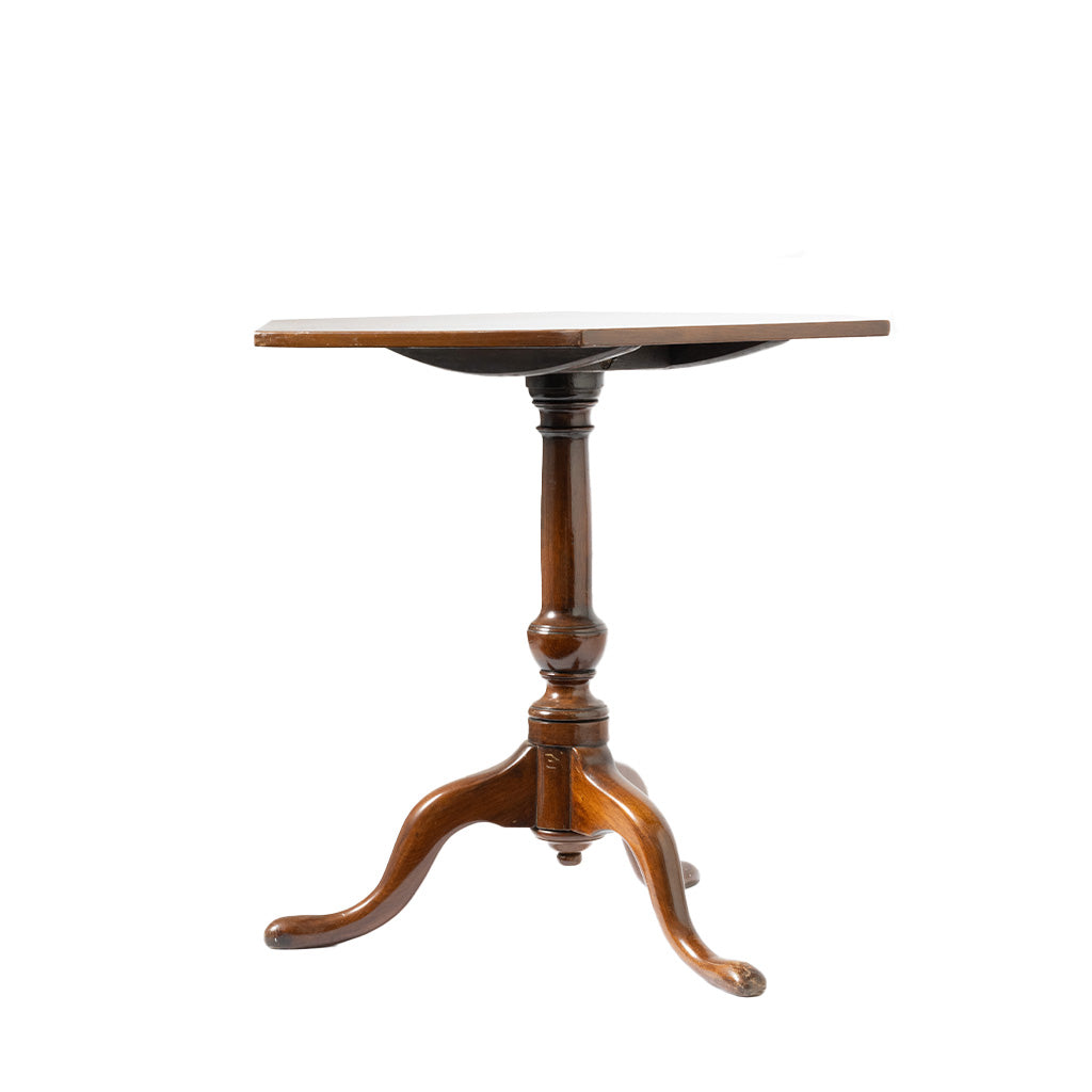 A vintage wooden pedestal table with a hexagon top, turned central post, and three curved legs, shown on a plain white background.