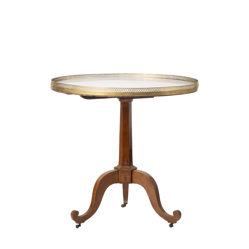 A round pedestal table with a gold brass mesh top and a curved brown wooden base on casters, shown against a plain white background.