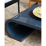 Blue coffee table with a decorative plate on a patterned rug