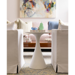 White ceramic Halo Bowl with smooth curved pedestal base on wooden coffee table.