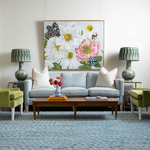 pale blue couch with green lamps