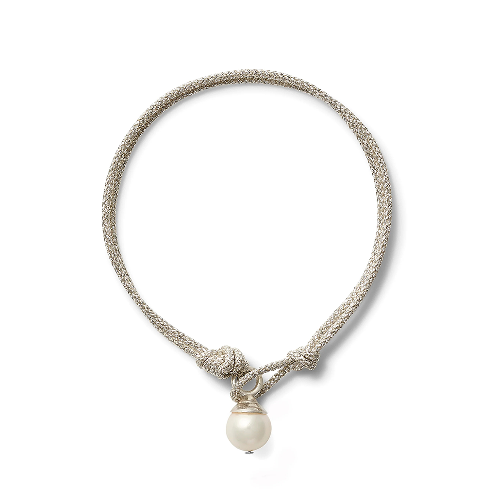 A silver-toned braided cord bracelet with a knotted toggle and a single white pearl pendant, shown on a clean white background.