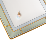Decorative tray with an opal heart pendant on a white background