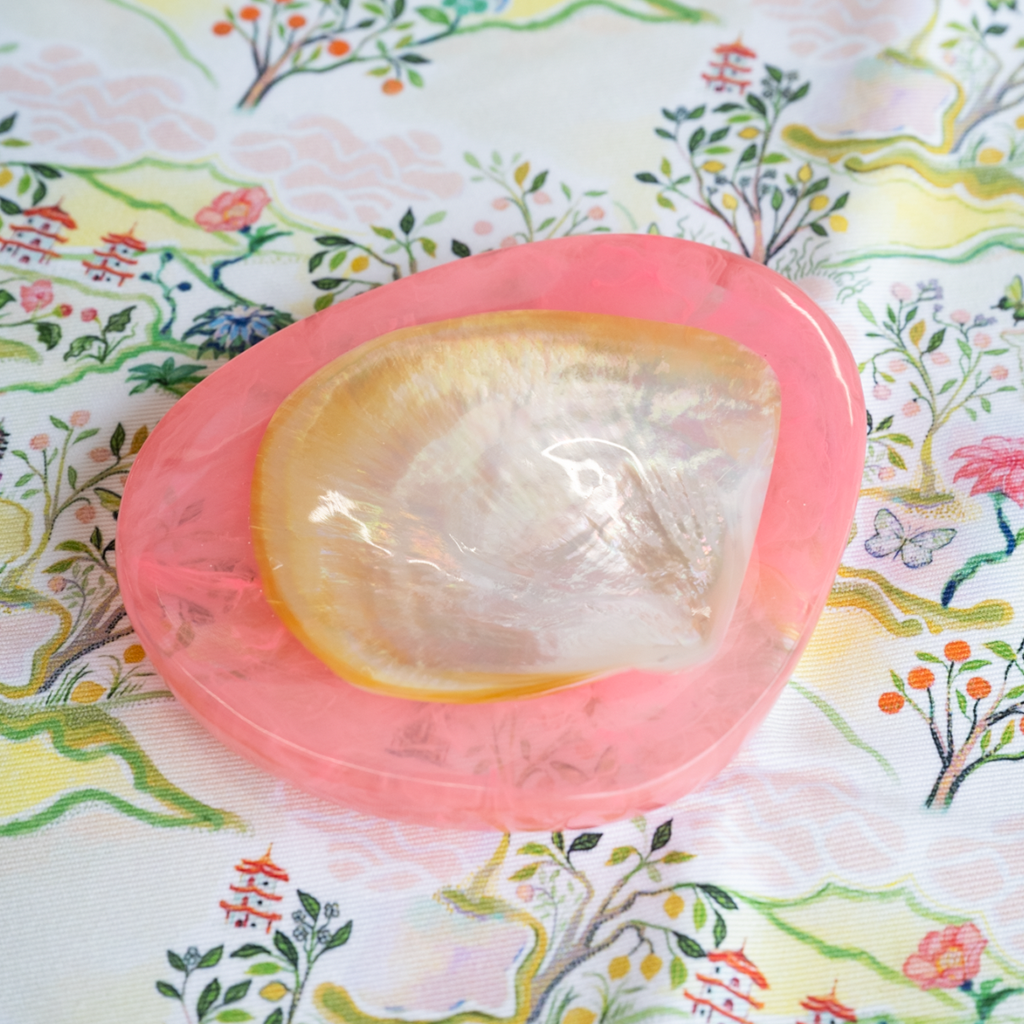 Pink caviar dish on a floral-patterned fabric background