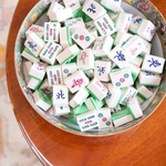 mahjong tile soaps in a bowl on a wooden table