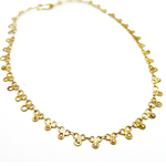 Gold necklace with diamond accents on a white background