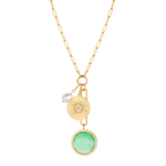 gold necklace with green stone and charms on a white background