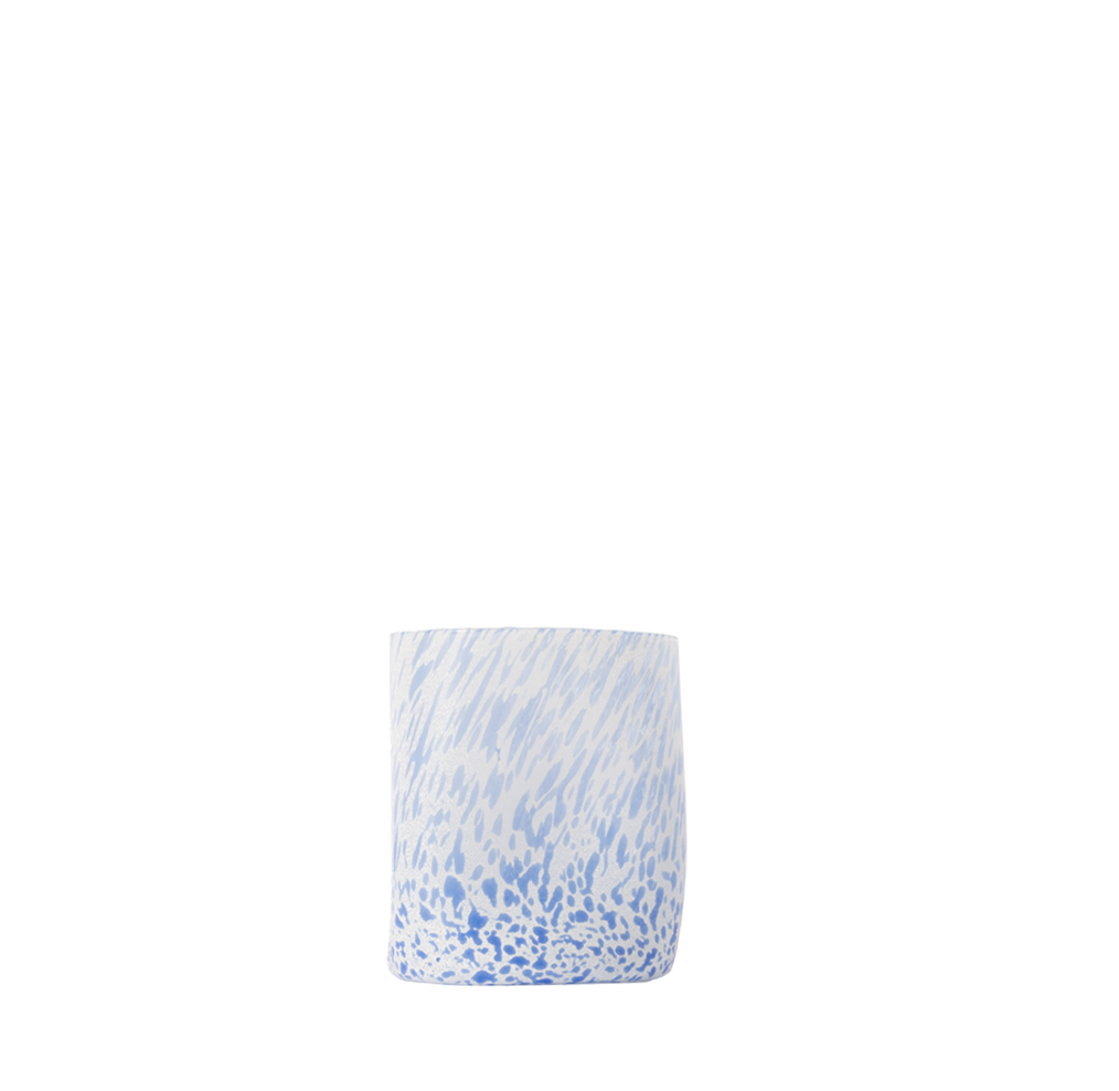 Drinking glass with blue and white pattern on a white background