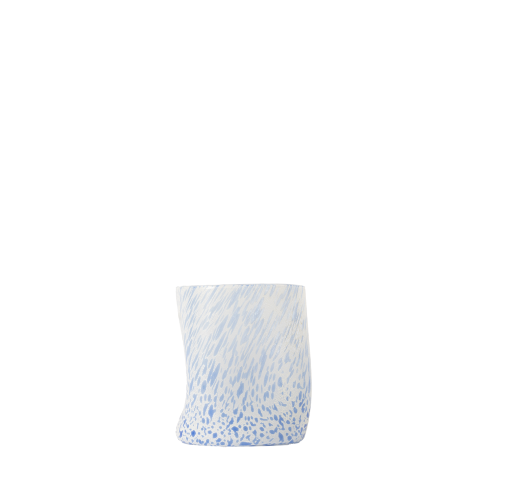 Drinking glass with blue and white pattern on a white background