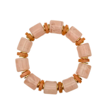 Pink and orange beaded bracelet with gold detailing on a white background