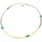 Gold necklace with turquoise stones on a white background
