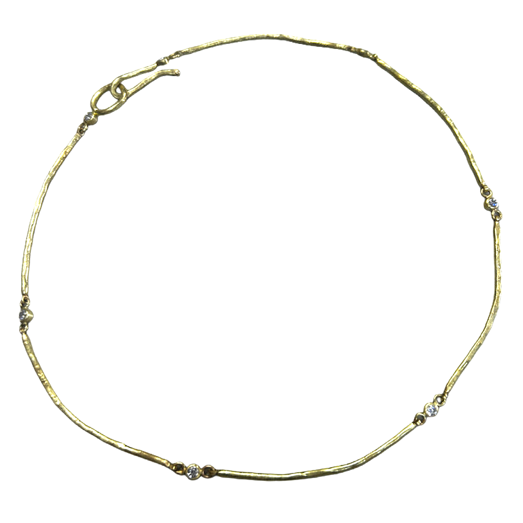 Gold necklace with small diamonds on a white background