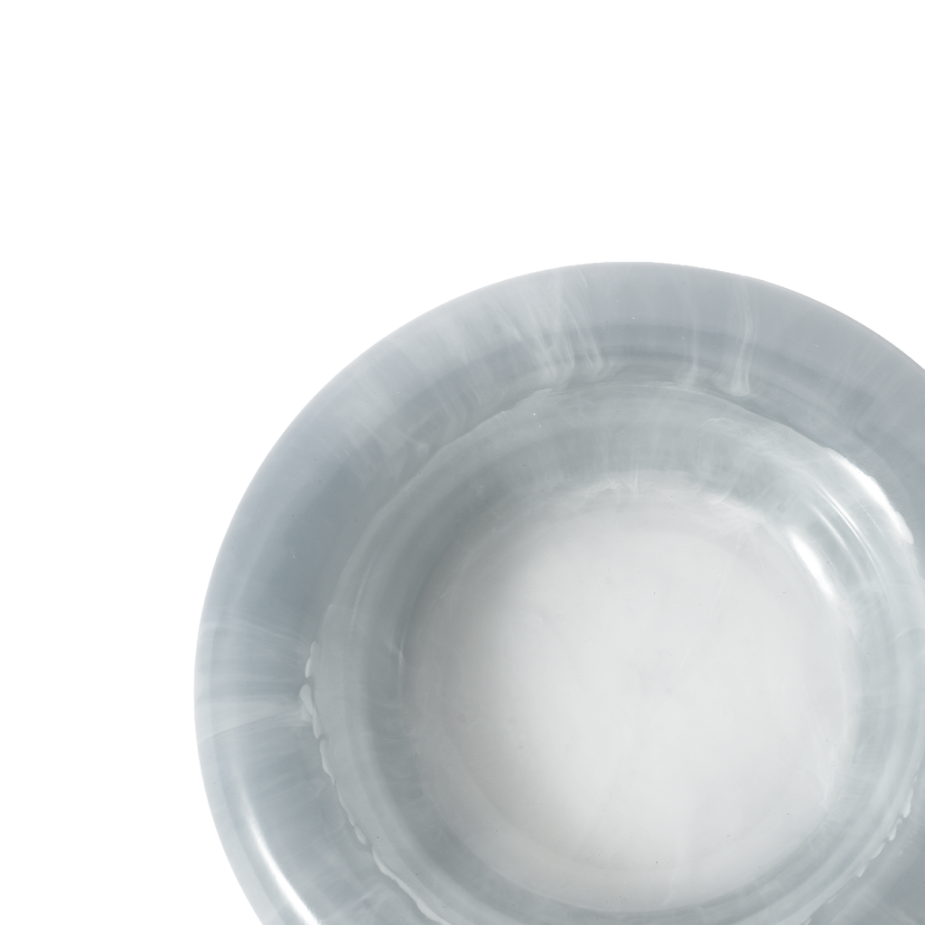 Close up of a round blue resin catch all dish on a white background