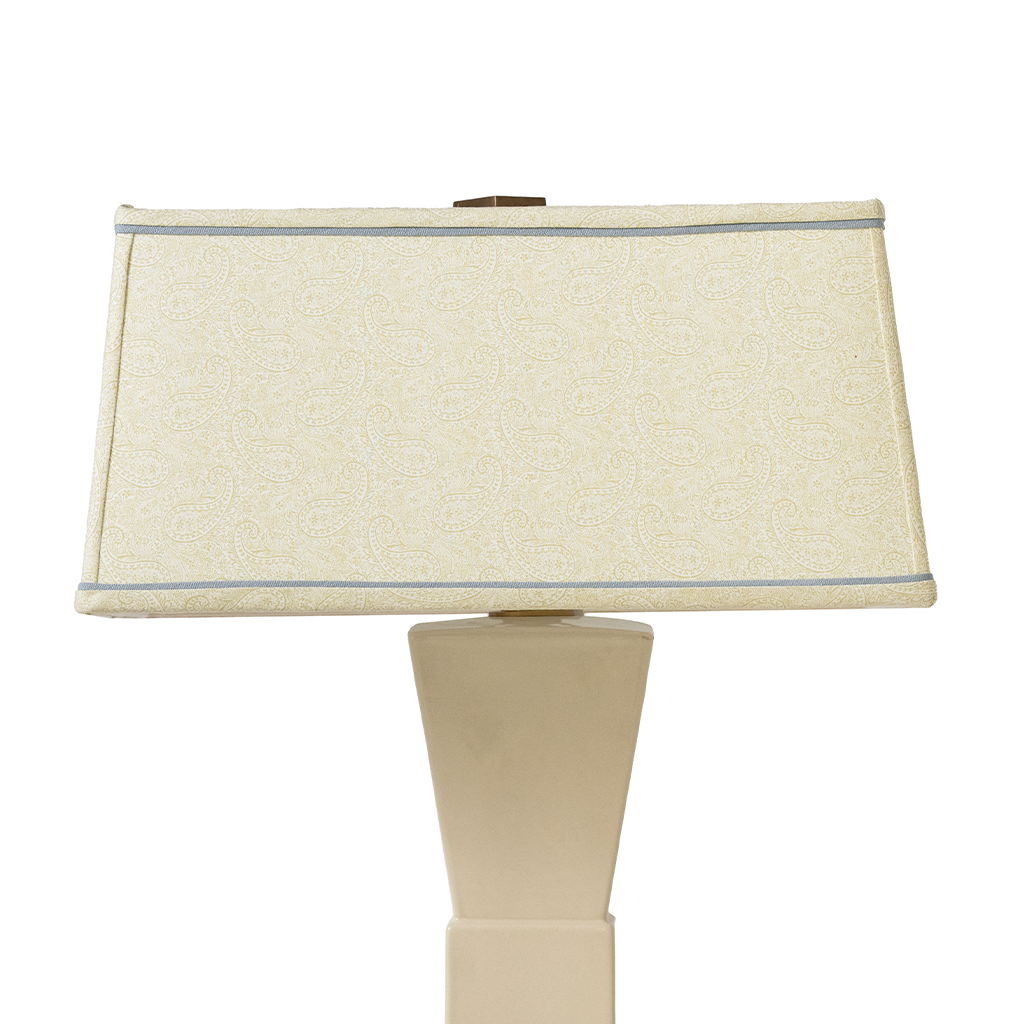 Beige table lamp with a rectangular beige shade on a white background